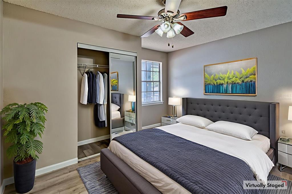 3705 Southwest 27th Street, Unit 926 Gainesville, FL 32608 - Photo 5 of 39 a bedroom with a large bed and a chandelier