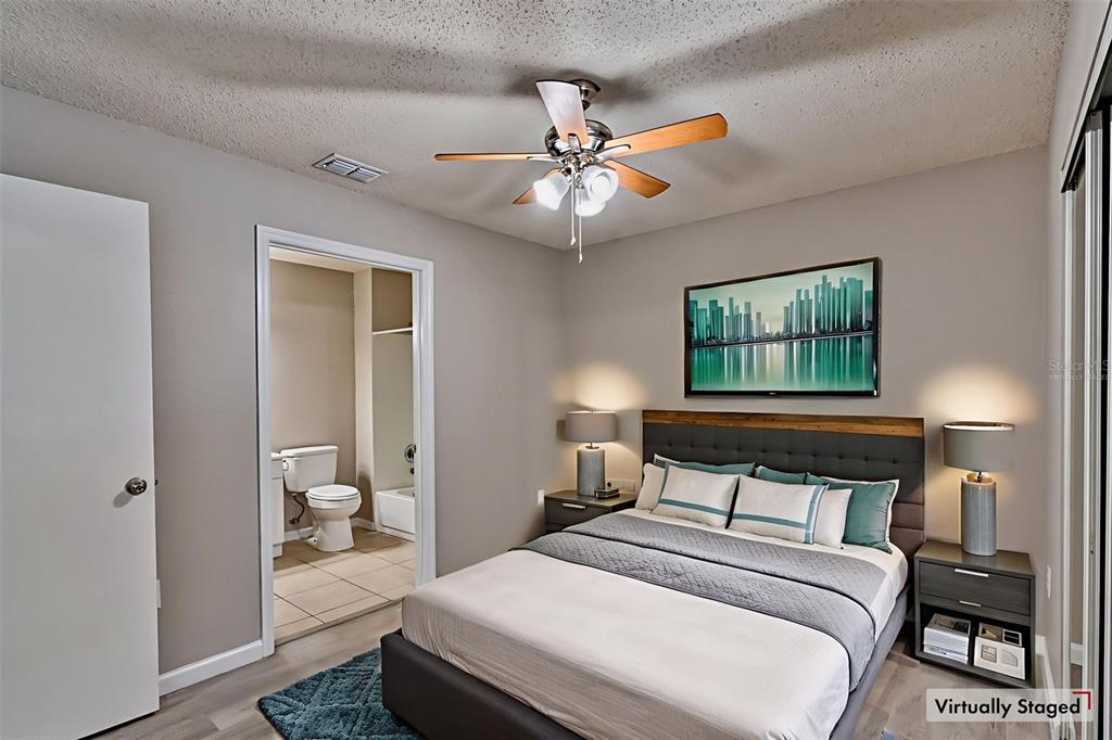 3705 Southwest 27th Street, Unit 926 Gainesville, FL 32608 - Photo 6 of 39 a bedroom with a bed and a chandelier