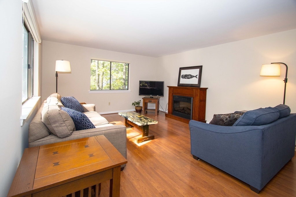 55 Mountain Gate Road, Unit 55 Ashland, MA 01721 - Photo 4 of 25 a living room with furniture and a fireplace