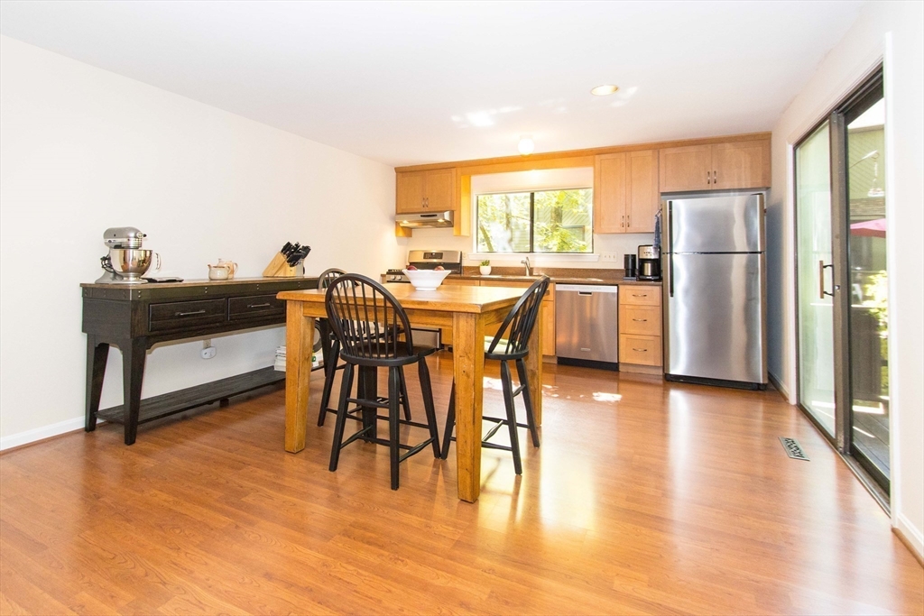 55 Mountain Gate Road, Unit 55 Ashland, MA 01721 - Photo 7 of 25 a view of a dining room with furniture and wooden floor