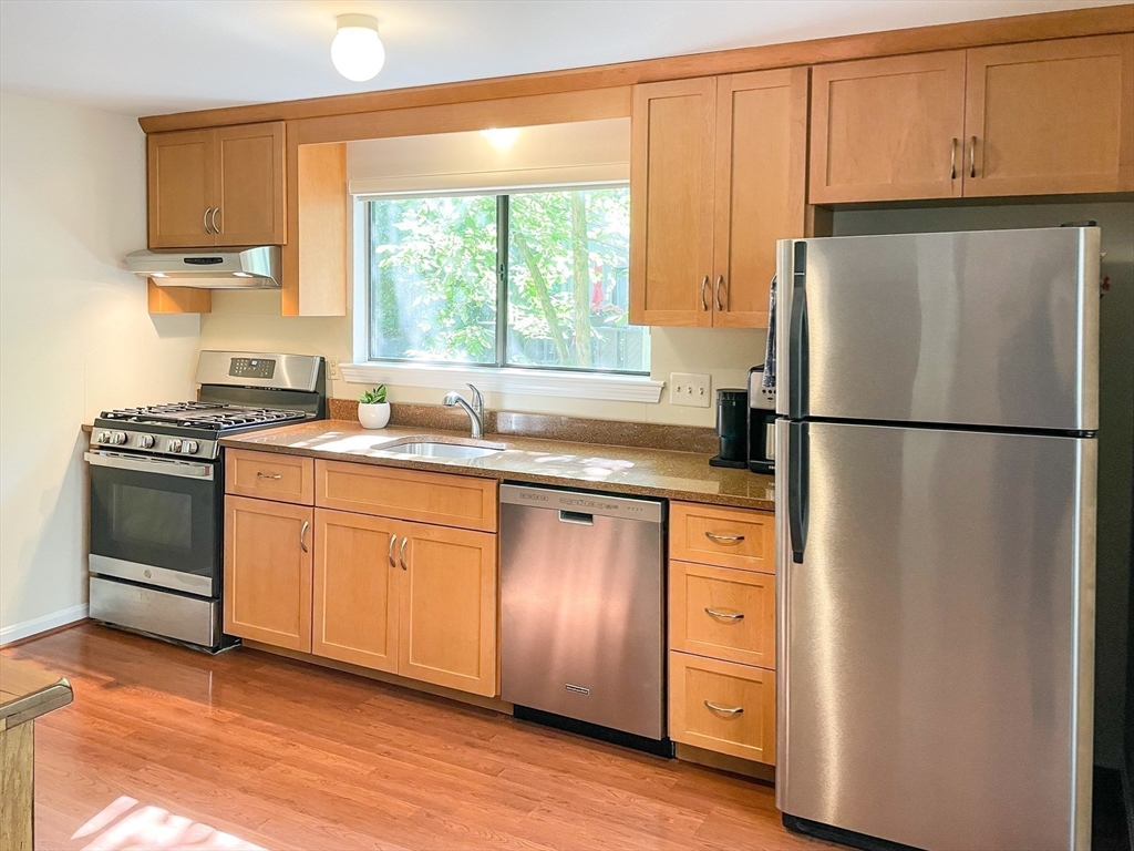 55 Mountain Gate Road, Unit 55 Ashland, MA 01721 - Photo 8 of 25 a kitchen with stainless steel appliances a refrigerator sink and cabinets