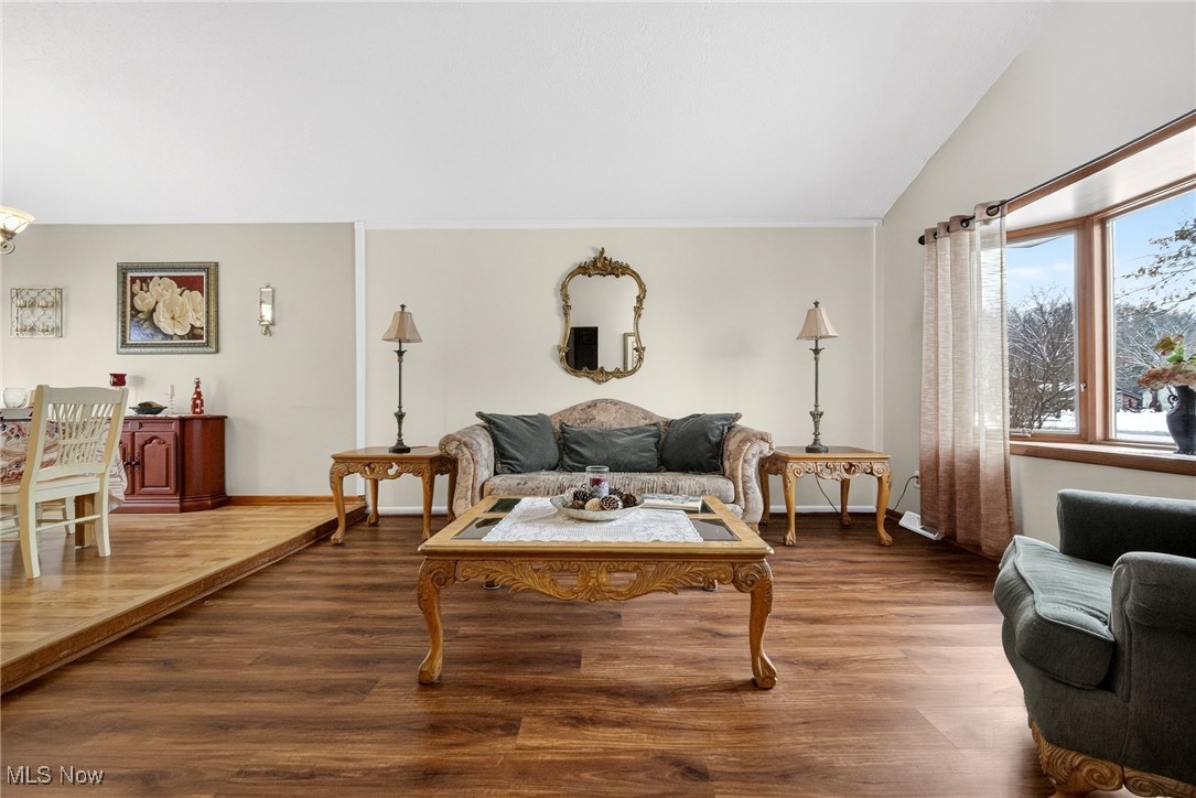 6379 Cary Road North Ridgeville, OH 44039 - Photo 4 of 29 Living room featuring wood finished floors and vaulted ceiling