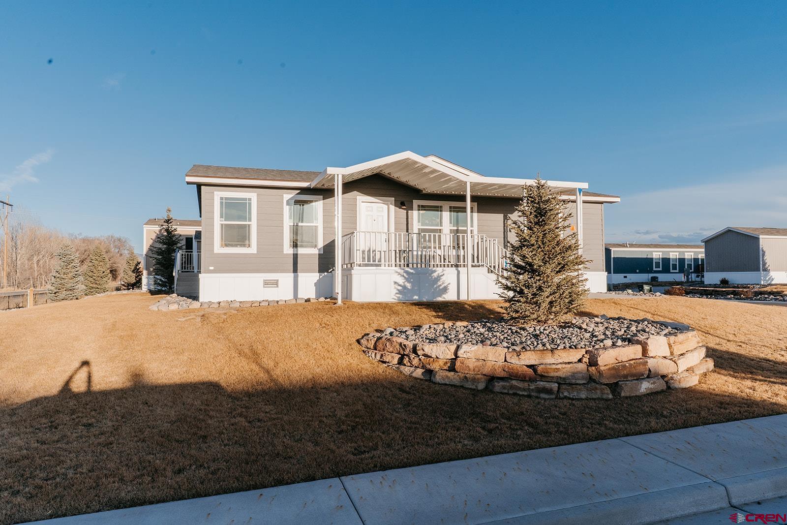 62650 Lasalle Road, Unit 325 Montrose, CO 81403 - Photo 1 of 24 a front view of a house with garden