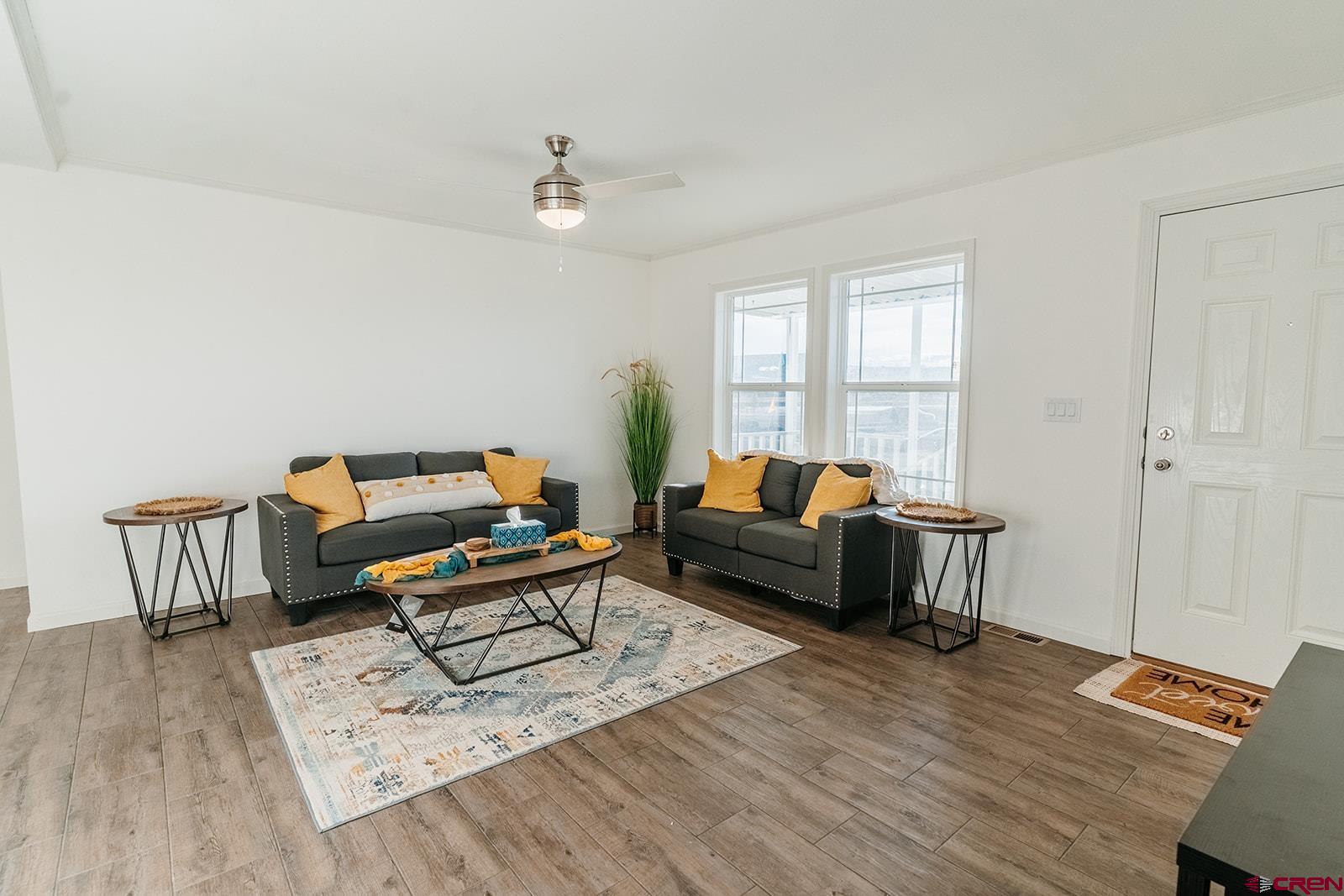 62650 Lasalle Road, Unit 325 Montrose, CO 81403 - Photo 12 of 24 a living room with furniture a rug and a window