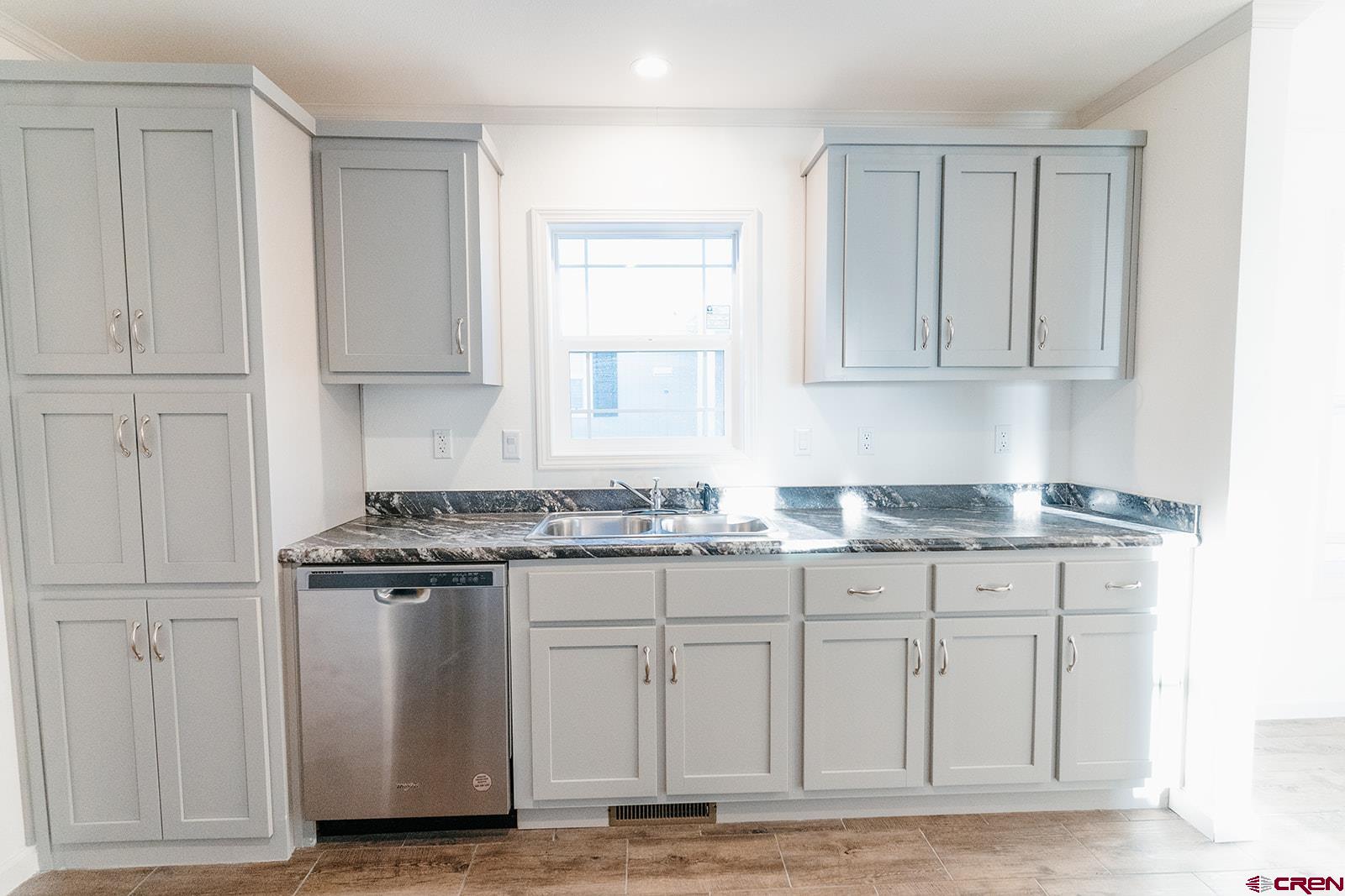 62650 Lasalle Road, Unit 325 Montrose, CO 81403 - Photo 18 of 24 a kitchen with granite countertop a stove sink and cabinets