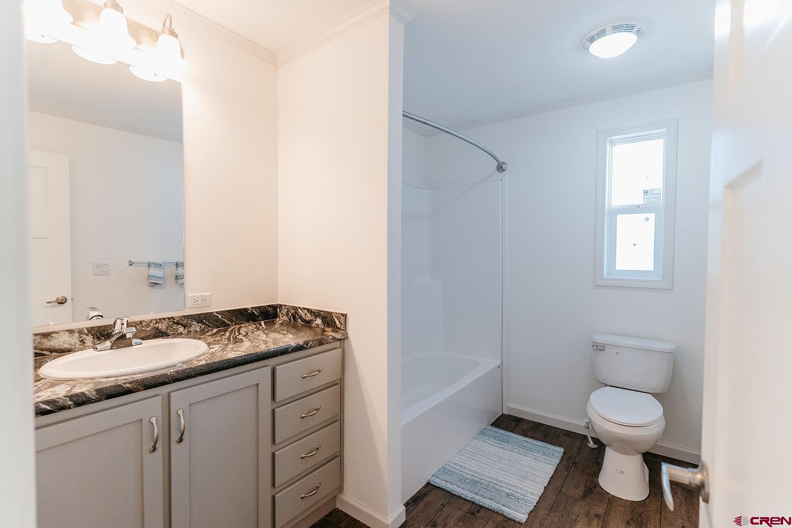 62650 Lasalle Road, Unit 325 Montrose, CO 81403 - Photo 24 of 24 a bath room with a sink a toilet and a vanity