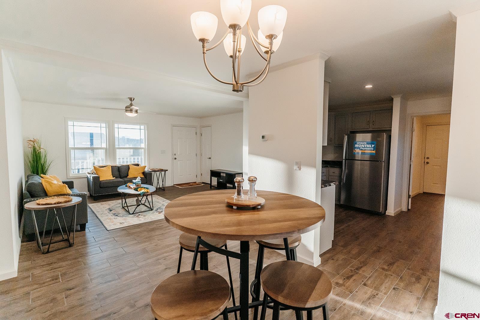 62650 Lasalle Road, Unit 325 Montrose, CO 81403 - Photo 6 of 24 a view of a dining room with furniture and wooden floor