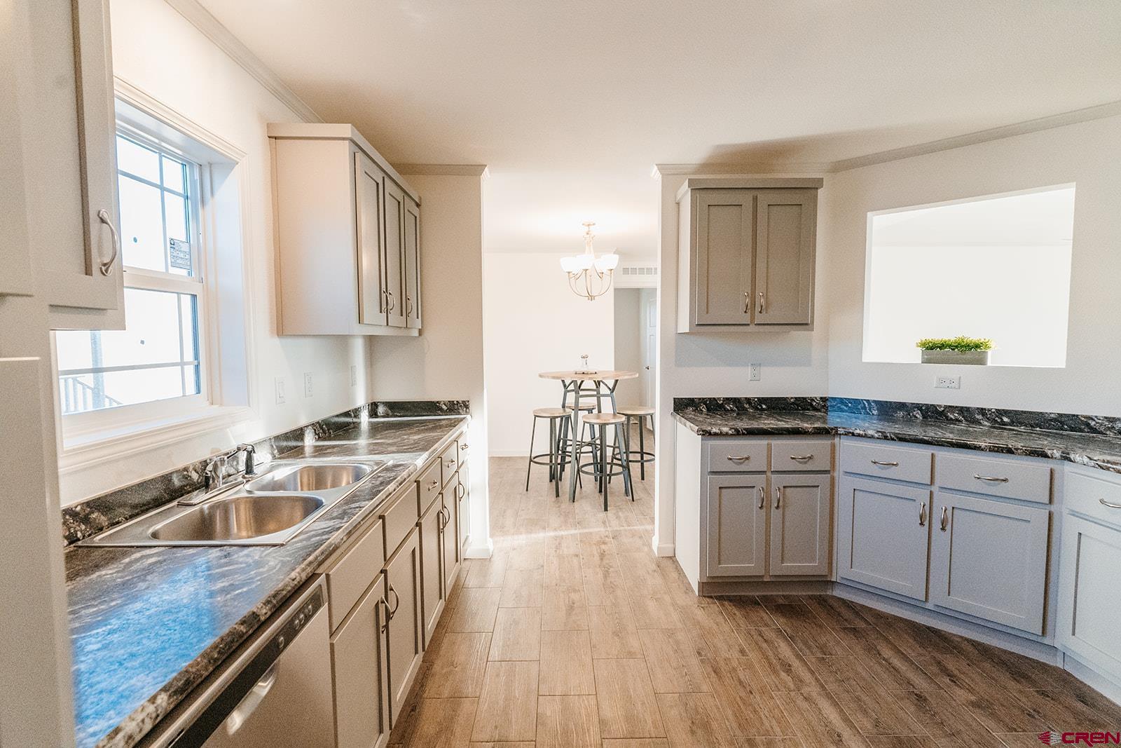 62650 Lasalle Road, Unit 325 Montrose, CO 81403 - Photo 8 of 24 a kitchen with stainless steel appliances granite countertop a sink stove and cabinets