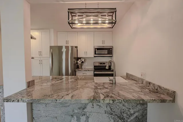 a kitchen with stainless steel appliances a refrigerator and stove