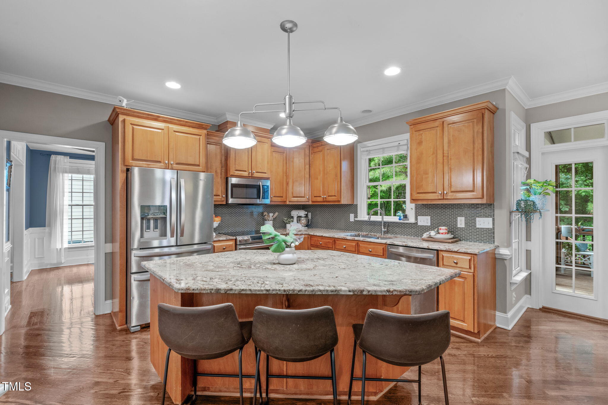 7929 Pine Timber Drive Raleigh, NC 27613 - Photo 14 of 53 a kitchen with granite countertop a stove a table and chairs in it