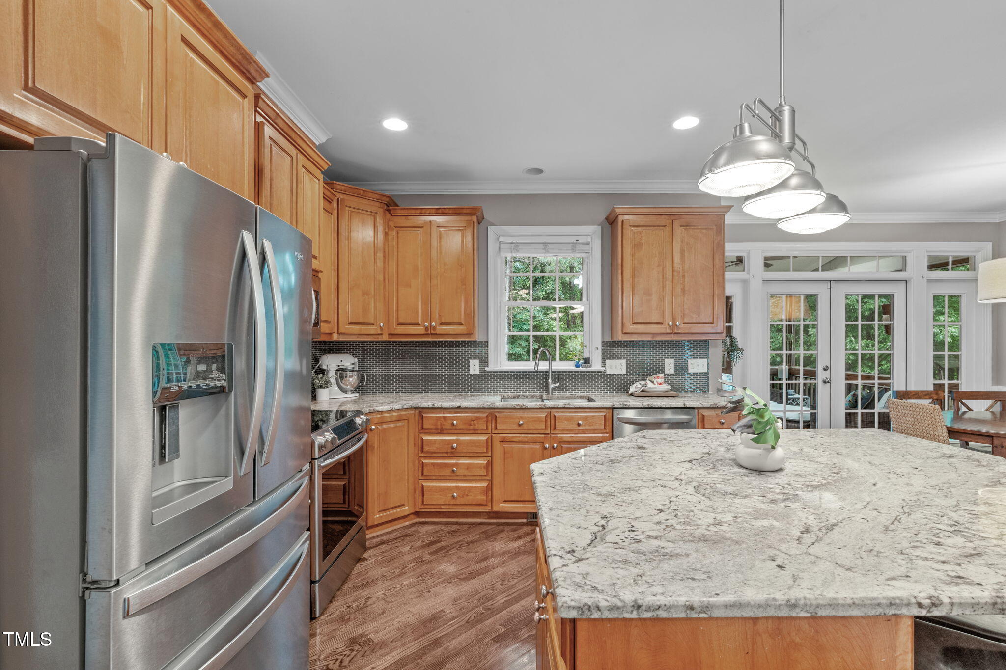7929 Pine Timber Drive Raleigh, NC 27613 - Photo 15 of 53 a kitchen with stainless steel appliances granite countertop a refrigerator a sink dishwasher a stove and white countertops with wooden floor