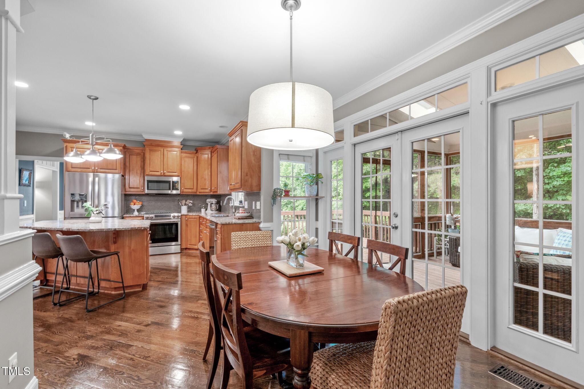 7929 Pine Timber Drive Raleigh, NC 27613 - Photo 18 of 53 a dining room with furniture a chandelier and window
