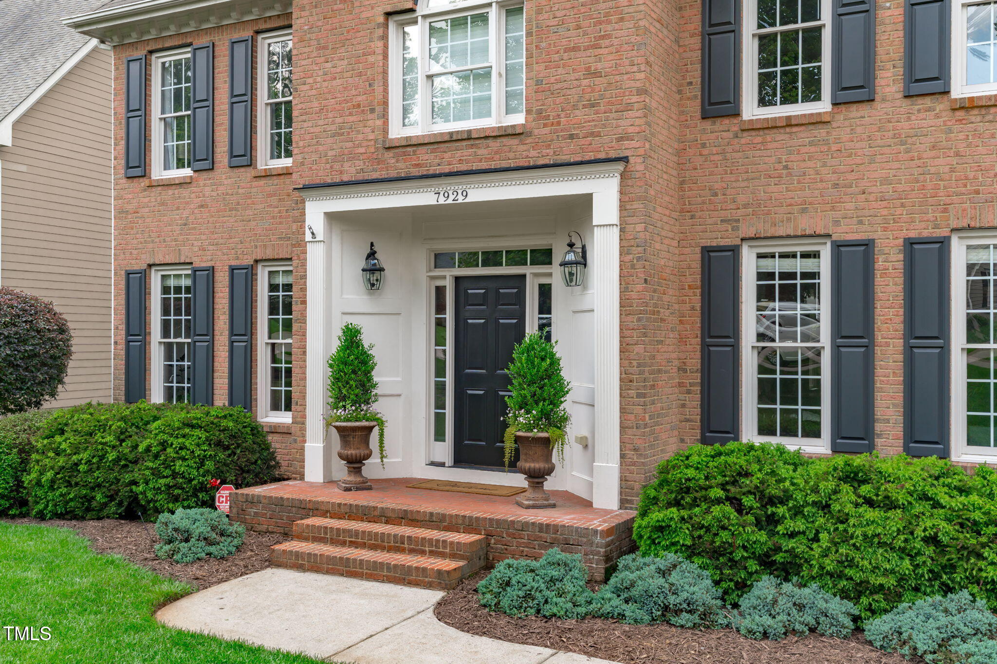 7929 Pine Timber Drive Raleigh, NC 27613 - Photo 2 of 53 a front view of a brick house with a yard and plants