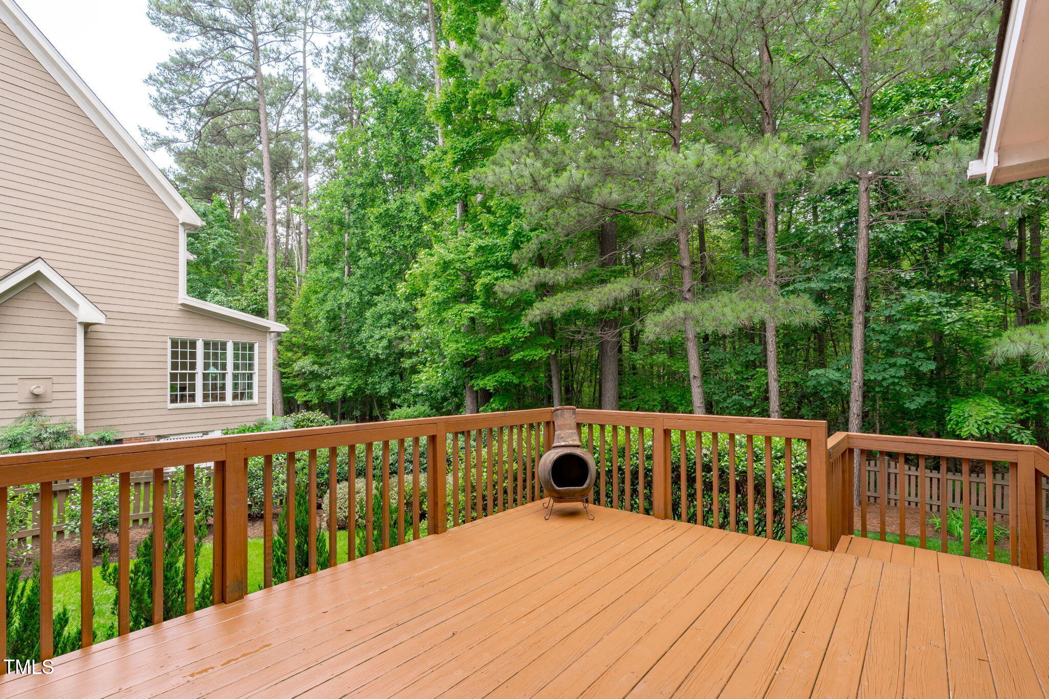 7929 Pine Timber Drive Raleigh, NC 27613 - Photo 23 of 53 a view of a wooden deck and a floor to ceiling window