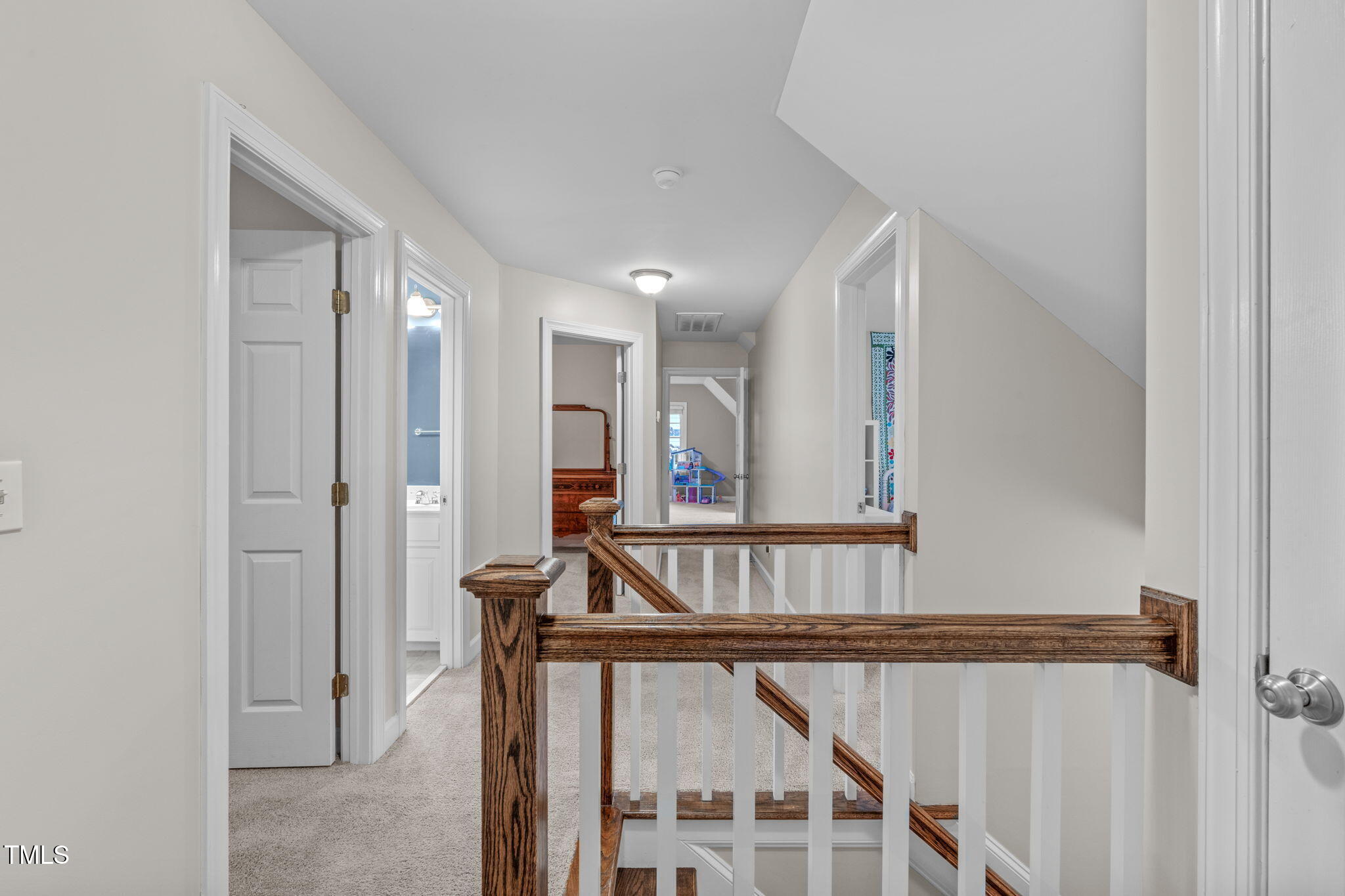 7929 Pine Timber Drive Raleigh, NC 27613 - Photo 25 of 53 a view of staircase with railing and white walls