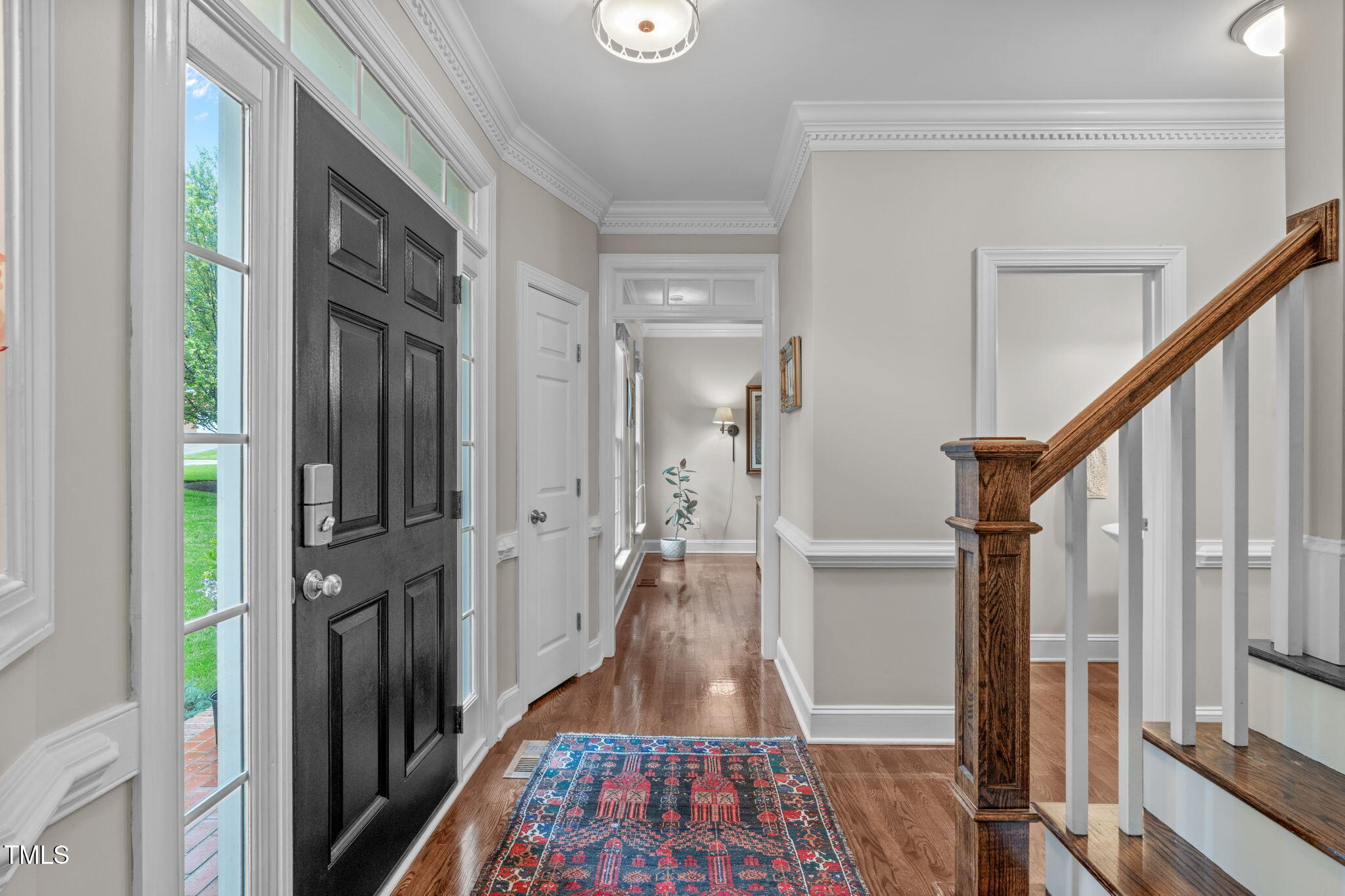 7929 Pine Timber Drive Raleigh, NC 27613 - Photo 4 of 53 a view of hallway with wooden floor and a rug
