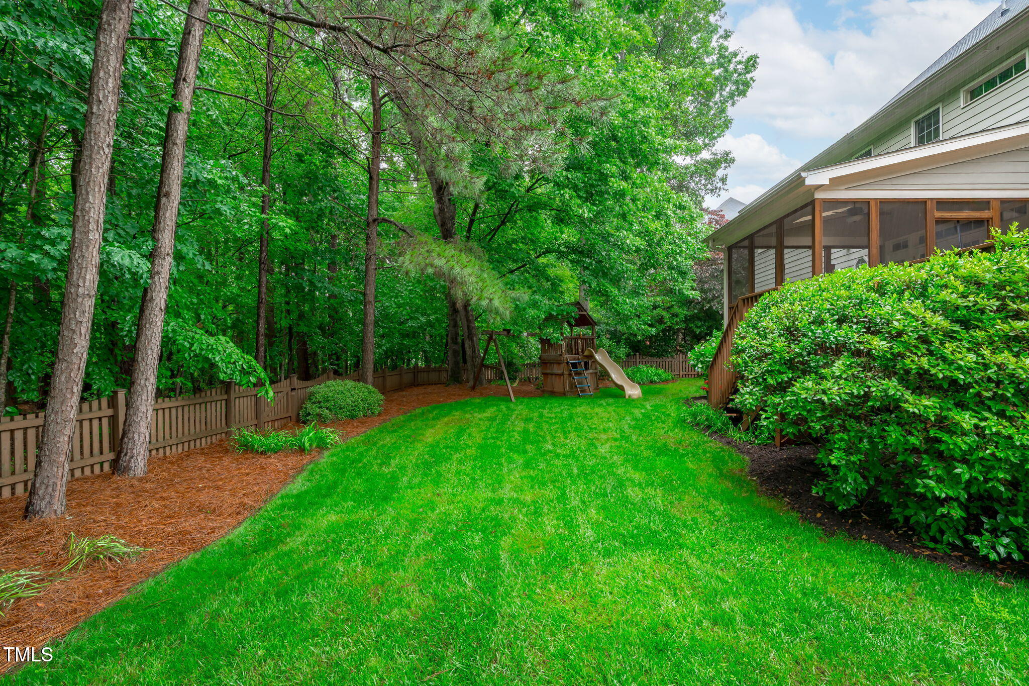 7929 Pine Timber Drive Raleigh, NC 27613 - Photo 42 of 53 a view of a backyard with a garden and trees