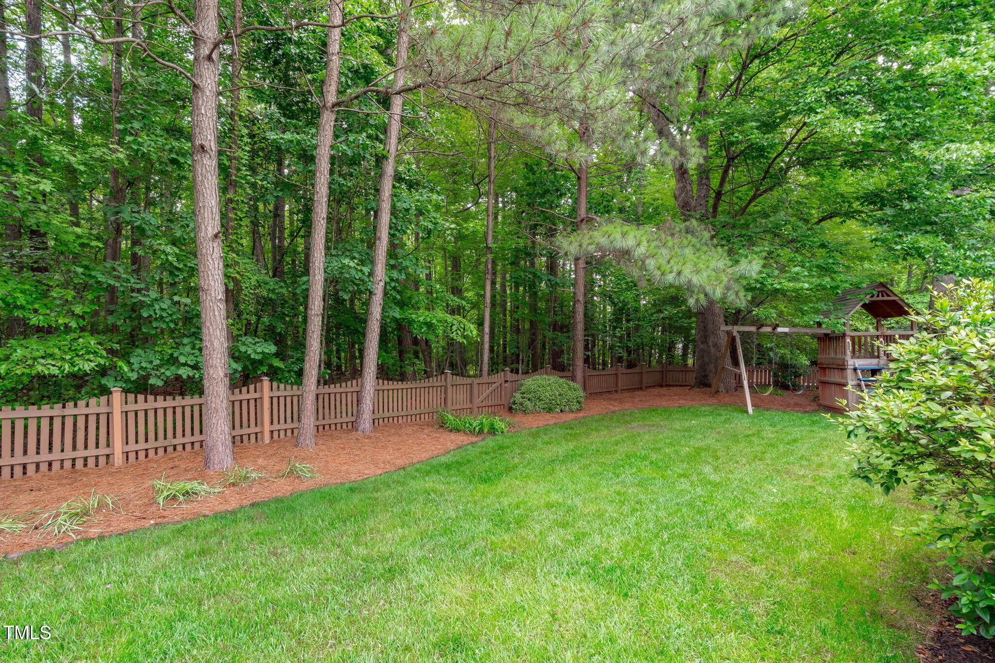 7929 Pine Timber Drive Raleigh, NC 27613 - Photo 46 of 53 a view of a chair and table and the garden