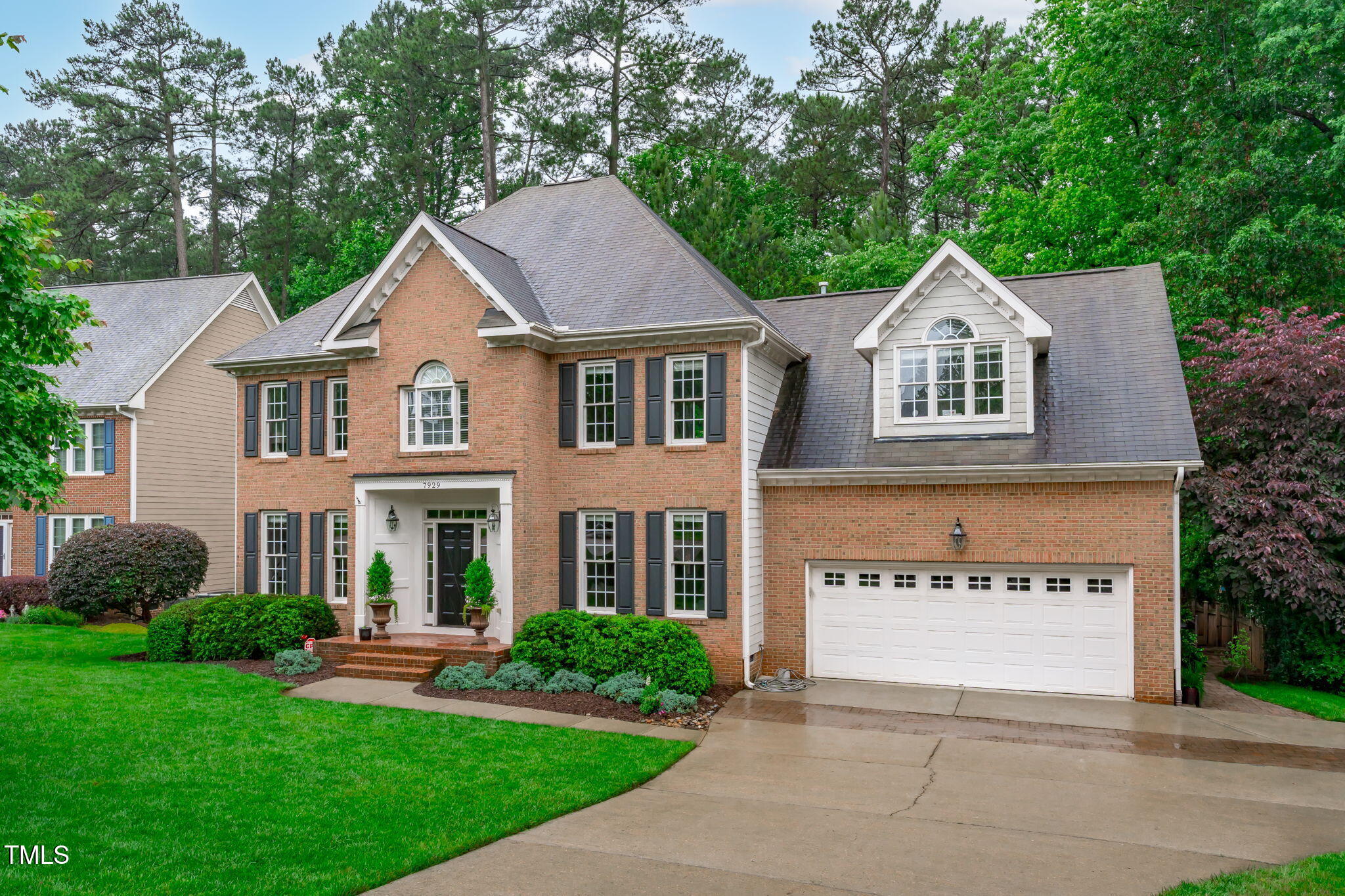 7929 Pine Timber Drive Raleigh, NC 27613 - Photo 53 of 53 a front view of a house with a yard and garage
