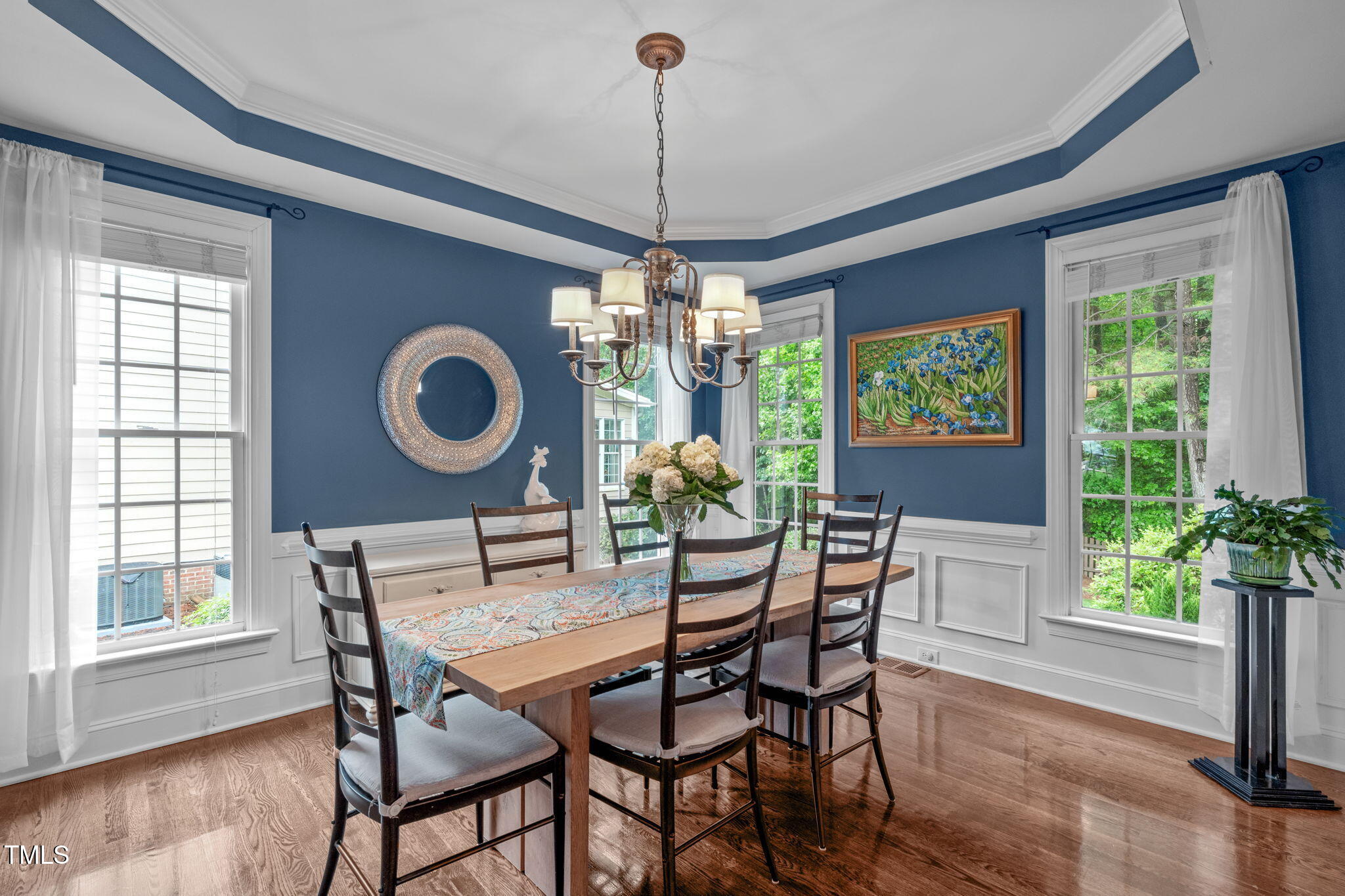 7929 Pine Timber Drive Raleigh, NC 27613 - Photo 8 of 53 a dining room with furniture potted plants and wooden floor