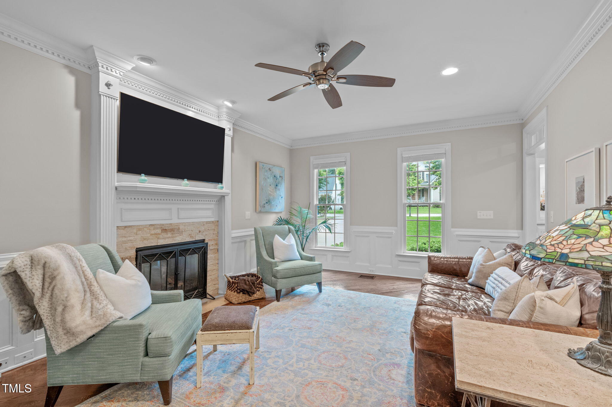 7929 Pine Timber Drive Raleigh, NC 27613 - Photo 10 of 53 a living room with furniture a fireplace and a flat screen tv