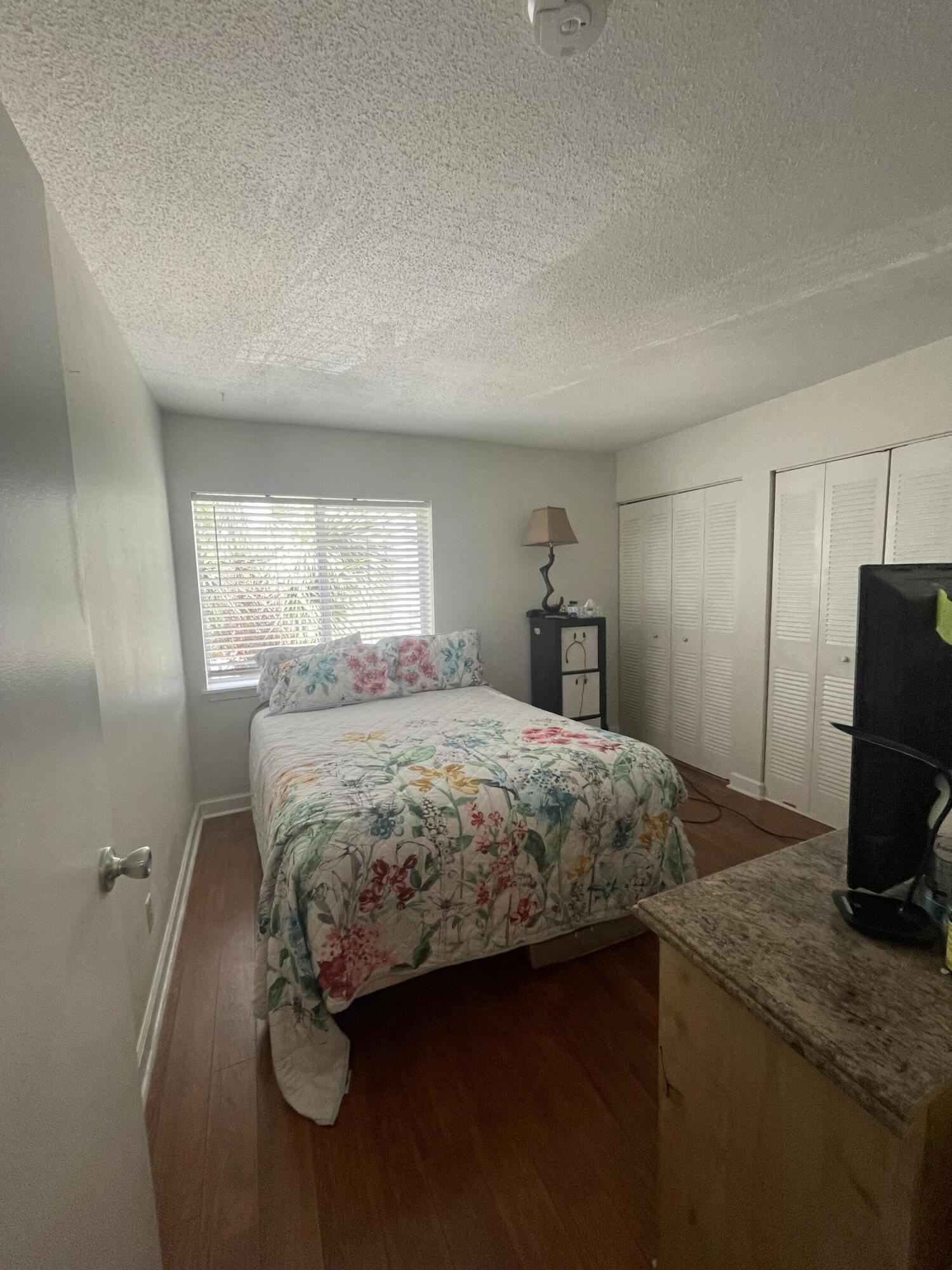 101 Old Ferry Road, Unit 29C Shalimar, FL 32579 - Photo 12 of 30 a bedroom with a bed and a refrigerator