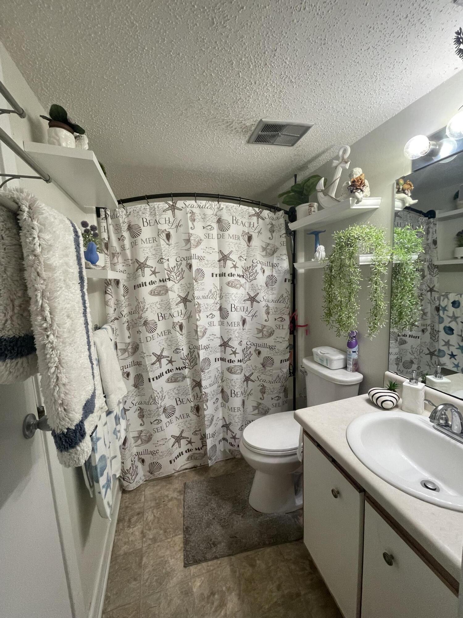 101 Old Ferry Road, Unit 29C Shalimar, FL 32579 - Photo 13 of 30 a bathroom with a sink toilet and shower