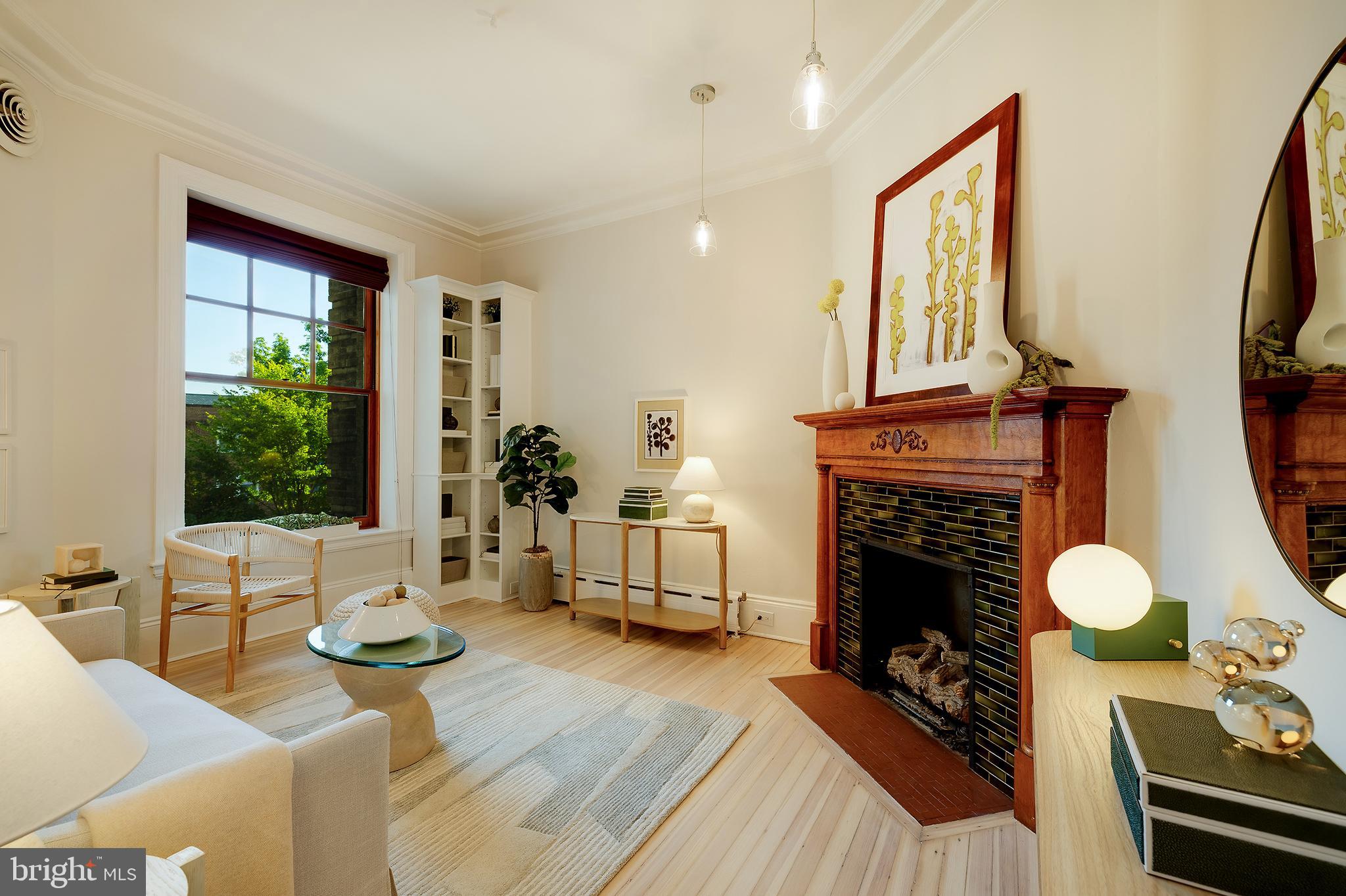 a living room with furniture a fireplace and a flat screen tv
