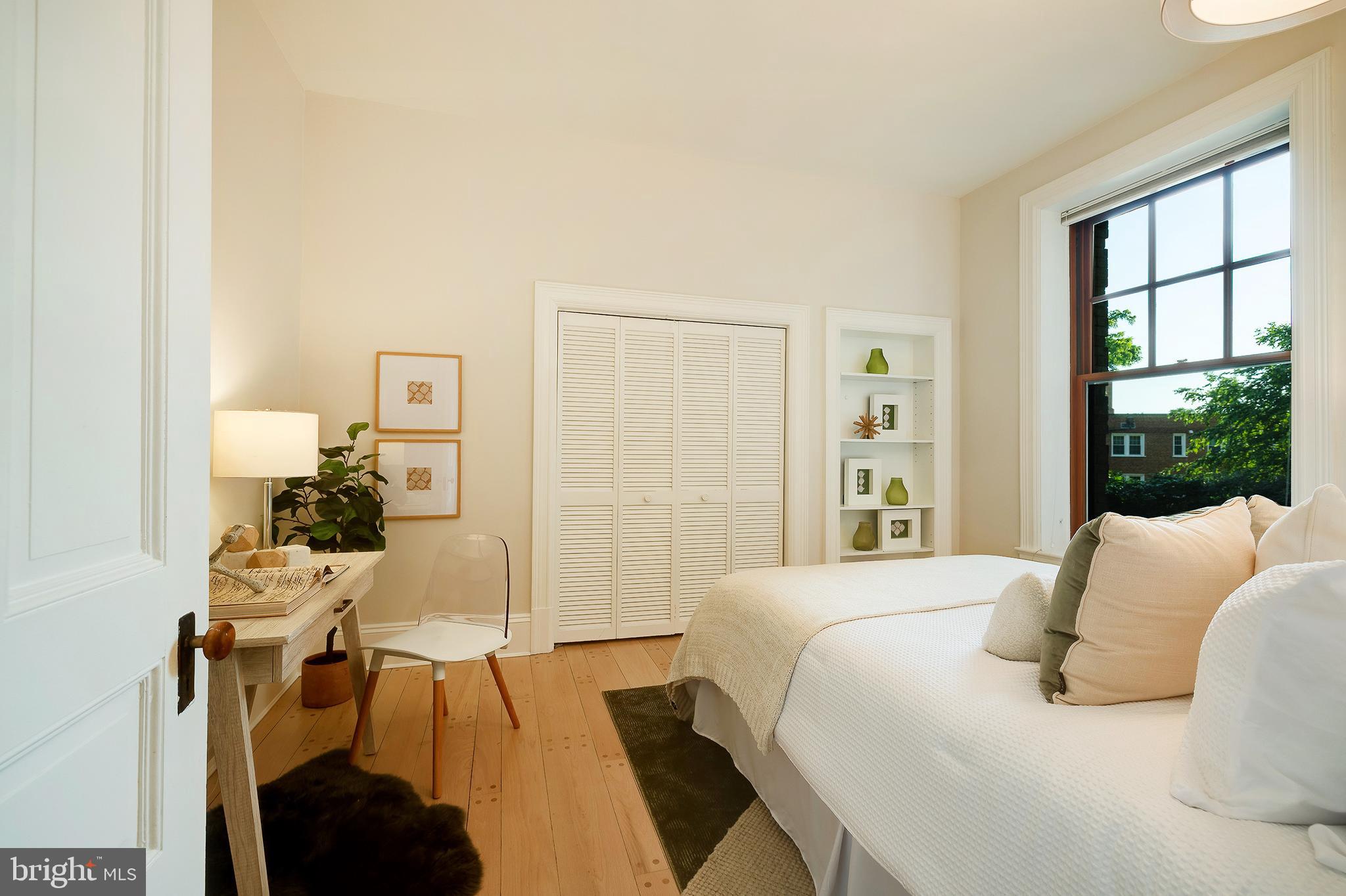 2853 Ontario Road Northwest, Unit 107 Washington, DC 20009 - Photo 16 of 39 a bedroom with a bed and a large window