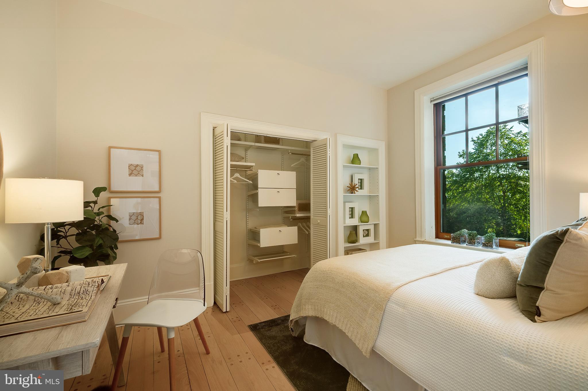 2853 Ontario Road Northwest, Unit 107 Washington, DC 20009 - Photo 17 of 39 a bedroom with a bed and wooden floor