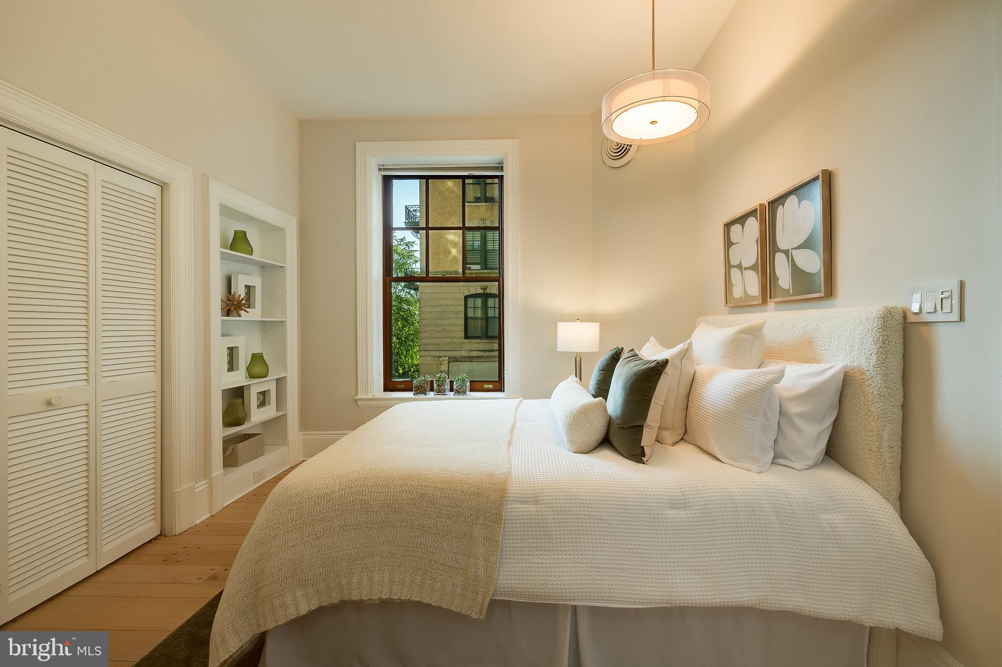 2853 Ontario Road Northwest, Unit 107 Washington, DC 20009 - Photo 18 of 39 a bedroom with a large bed and a chandelier