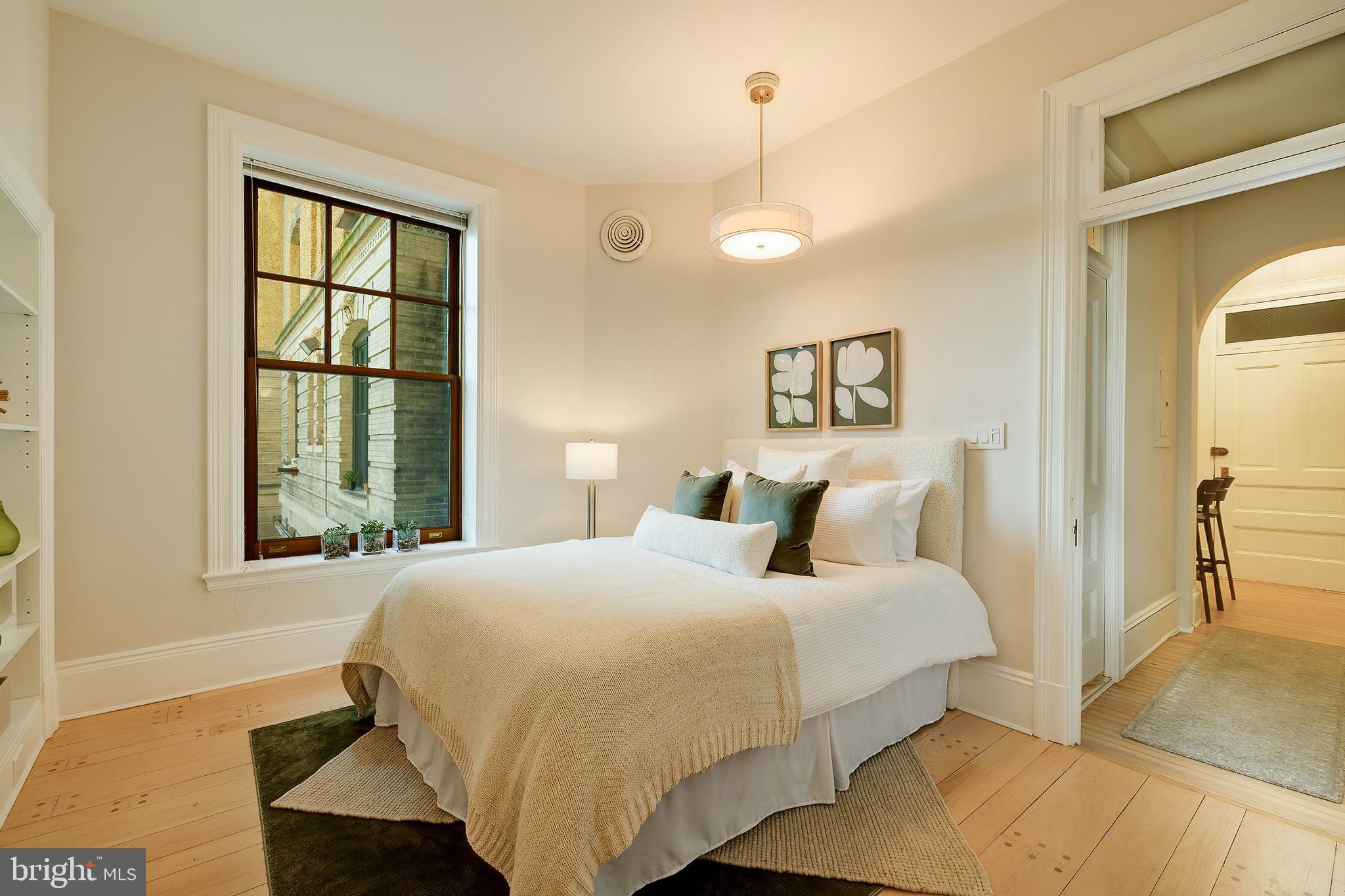 2853 Ontario Road Northwest, Unit 107 Washington, DC 20009 - Photo 19 of 39 a bedroom with a bed and a window