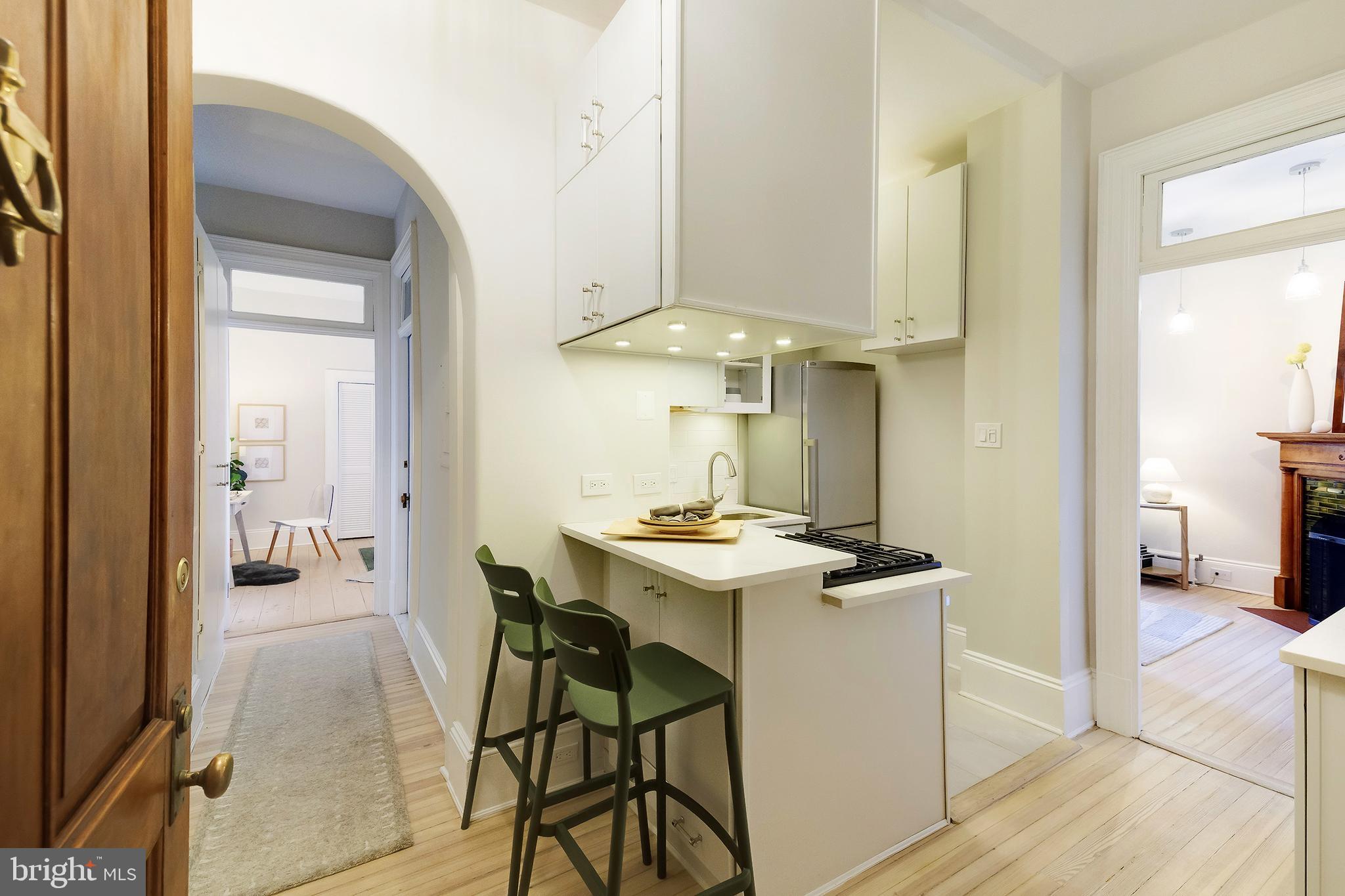 2853 Ontario Road Northwest, Unit 107 Washington, DC 20009 - Photo 6 of 39 a view of a dining room with furniture and a chandelier