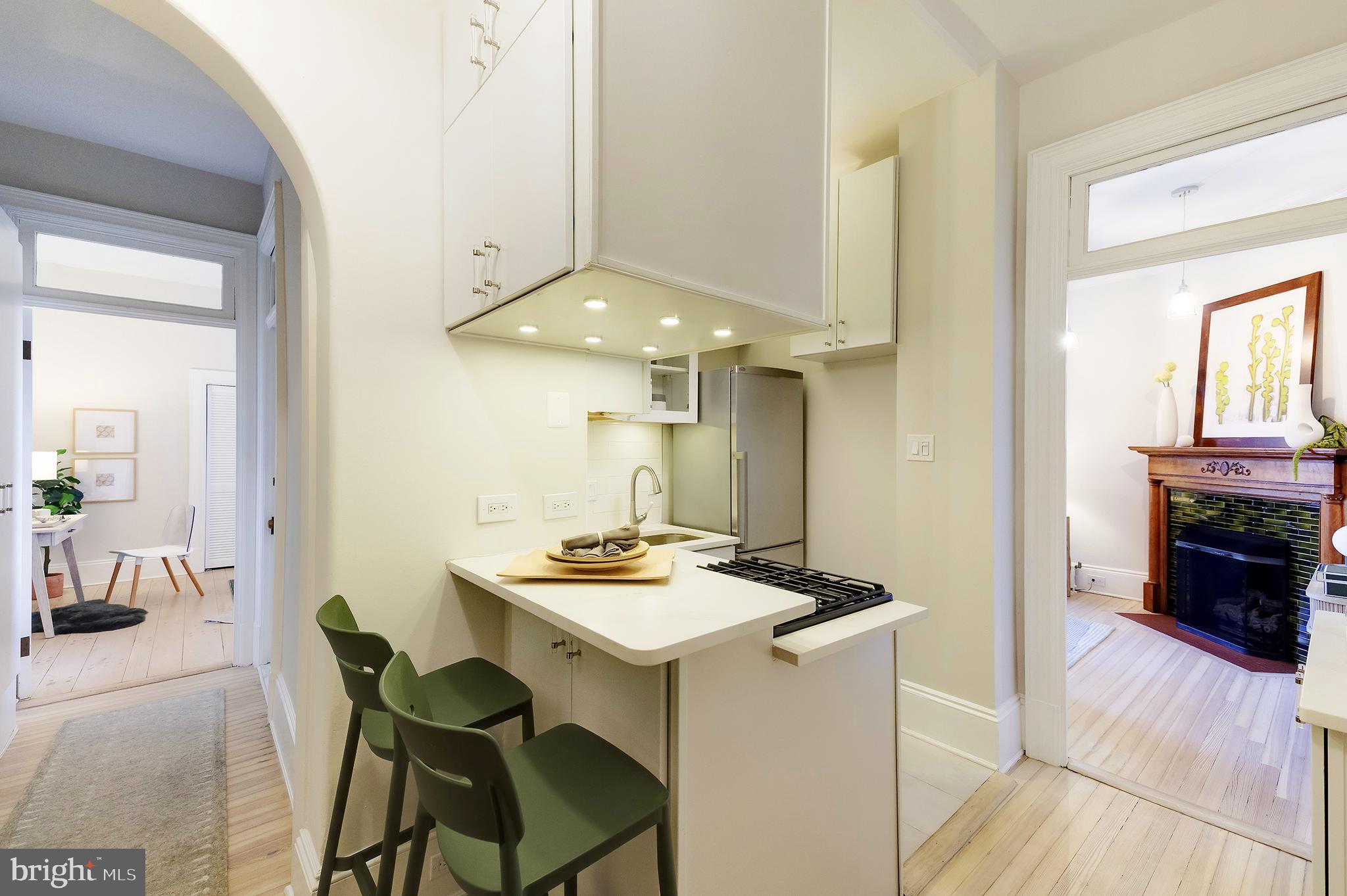 2853 Ontario Road Northwest, Unit 107 Washington, DC 20009 - Photo 7 of 39 a kitchen with a table and chairs