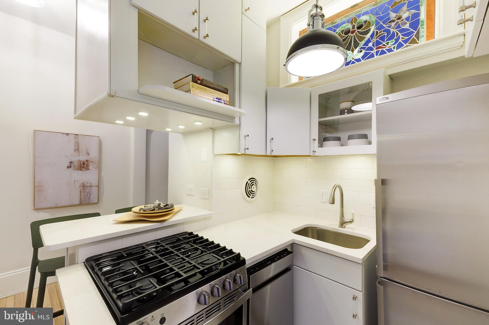 2853 Ontario Road Northwest, Unit 107 Washington, DC 20009 - Photo 10 of 39 a kitchen with a stove and a sink