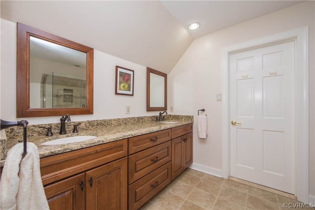 2729 West Brigstock Road Midlothian, VA 23113 - Photo 30 of 50 a spacious bathroom with a granite countertop sink a mirror and a