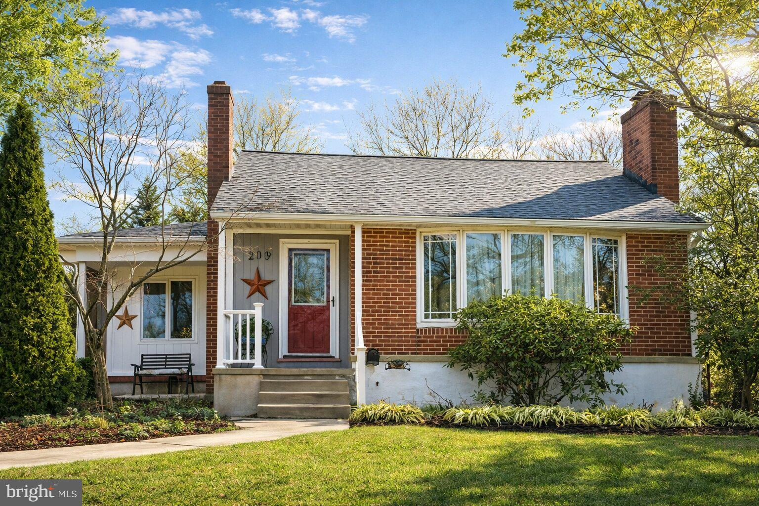 Charming brick home with lush greenery.