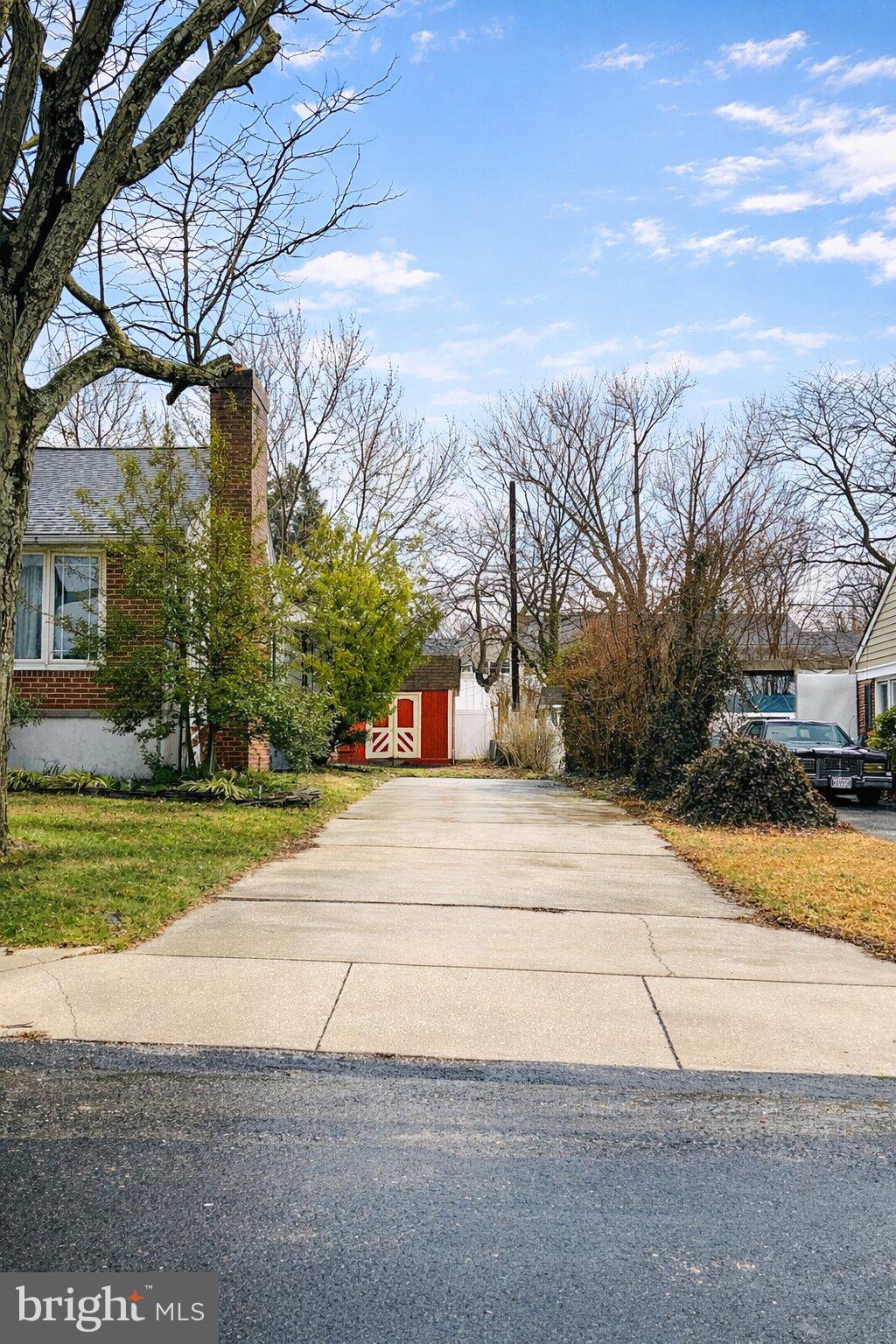 209 Mountain Road Linthicum Heights, MD 21090 - Photo 2 of 4 Charming driveway leads to a red barn.