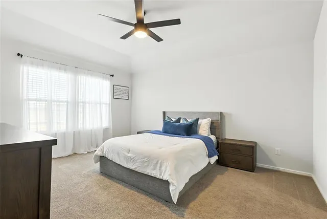 a bedroom with a bed and window