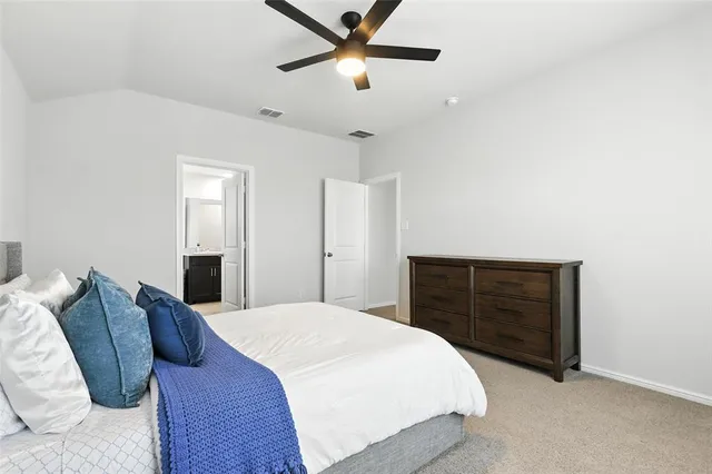 a bedroom with a bed and a dresser