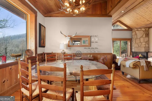 a kitchen with stainless steel appliances a refrigerator a stove a sink and white cabinets with wooden floor