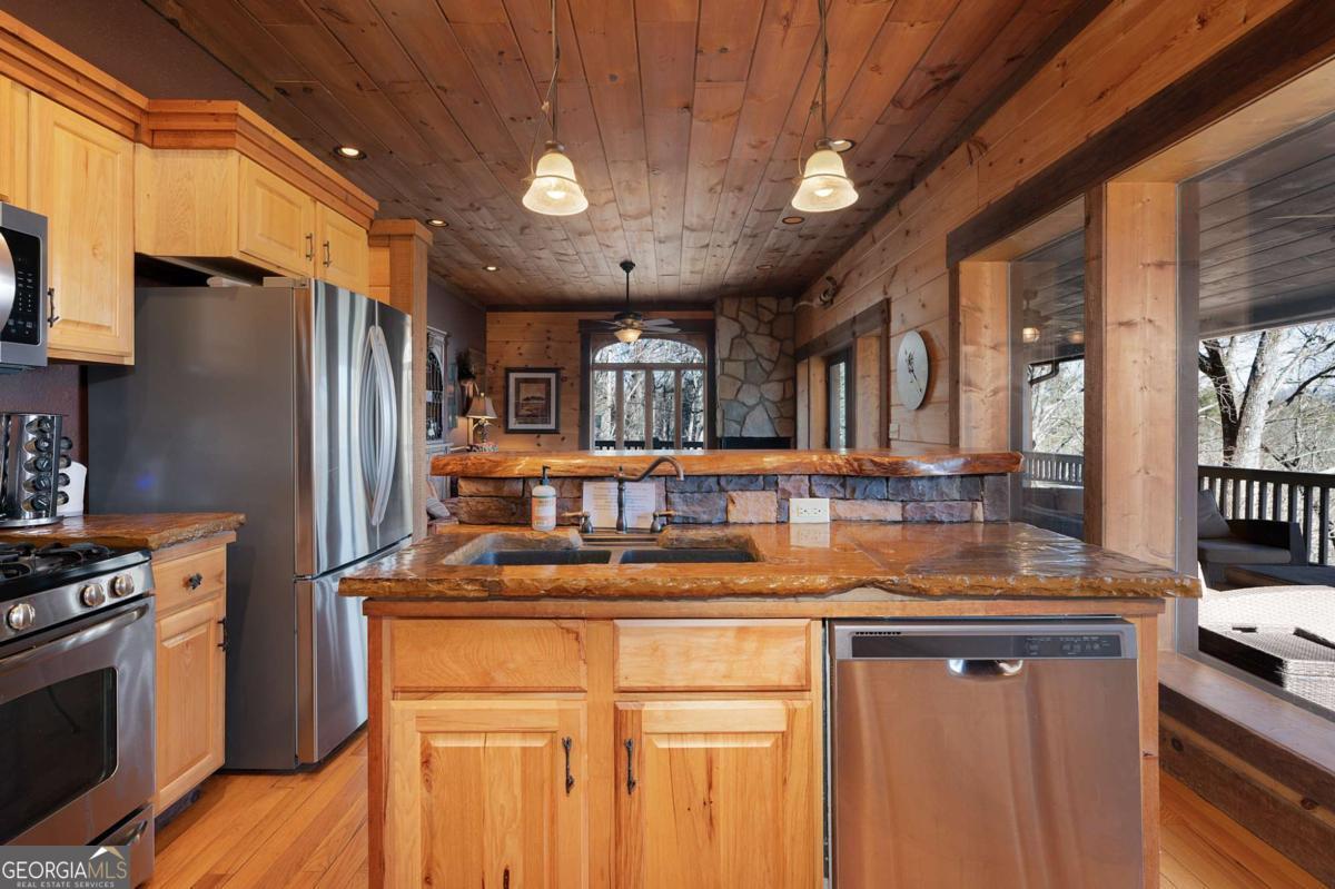244 Tipton Court Cherry Log, GA 30522 - Photo 20 of 84 a kitchen with stainless steel appliances granite countertop a sink a stove and a refrigerator
