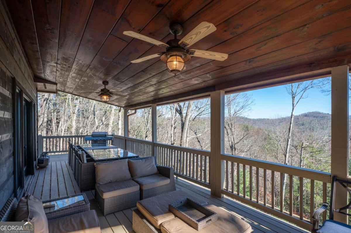 244 Tipton Court Cherry Log, GA 30522 - Photo 22 of 84 a living room with furniture a ceiling fan and a window