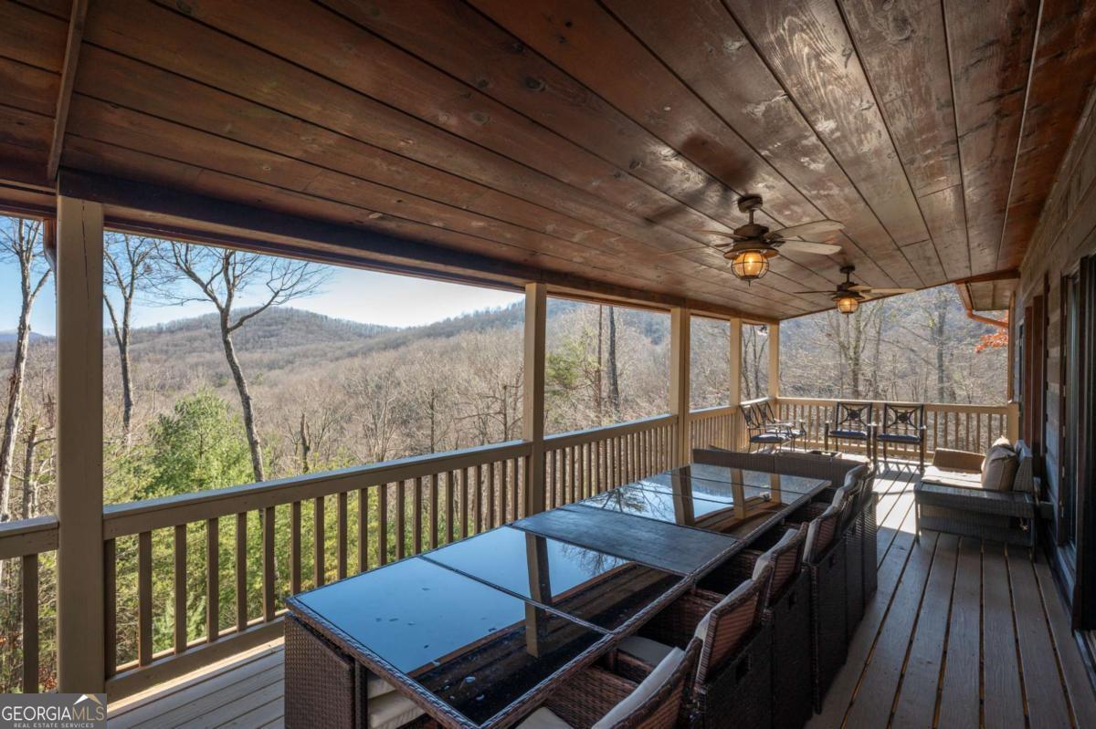 244 Tipton Court Cherry Log, GA 30522 - Photo 23 of 84 a view of a balcony with furniture and wooden floor
