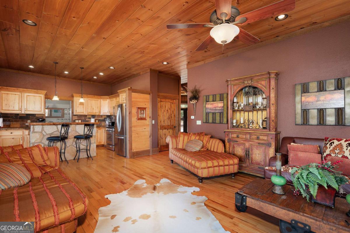 244 Tipton Court Cherry Log, GA 30522 - Photo 27 of 84 a living room with furniture and a chandelier
