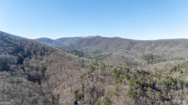 a view of a roof deck with couches and wooden floor