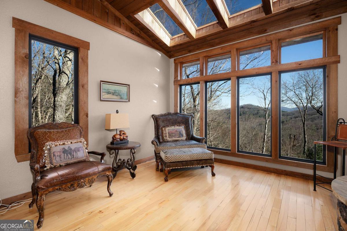 244 Tipton Court Cherry Log, GA 30522 - Photo 57 of 84 a living room with furniture and a floor to ceiling window