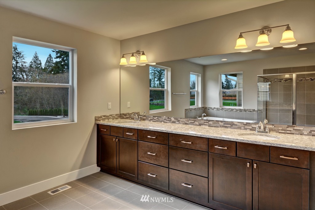 3527 178th Street Southeast, Unit 1032 Bothell, WA 98012 - Photo 6 of 15 a bathroom with a granite countertop sink mirror and double