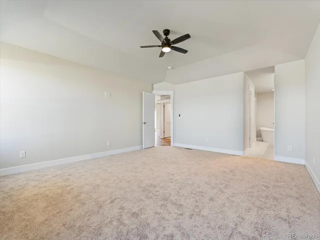 a view of a livingroom with a ceiling fan and window