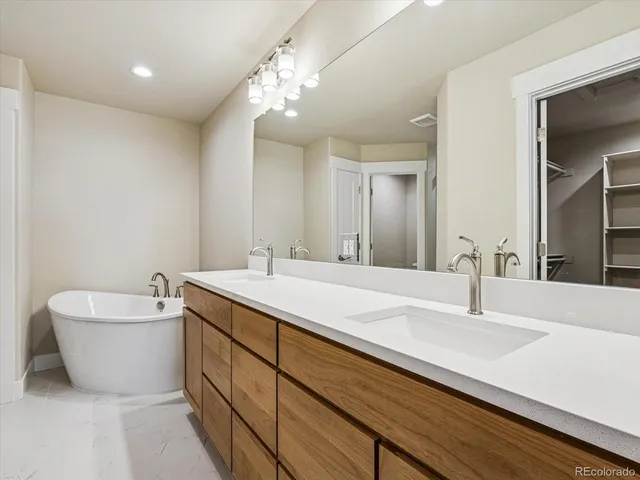 a bathroom with a double vanity sink and a bathtub